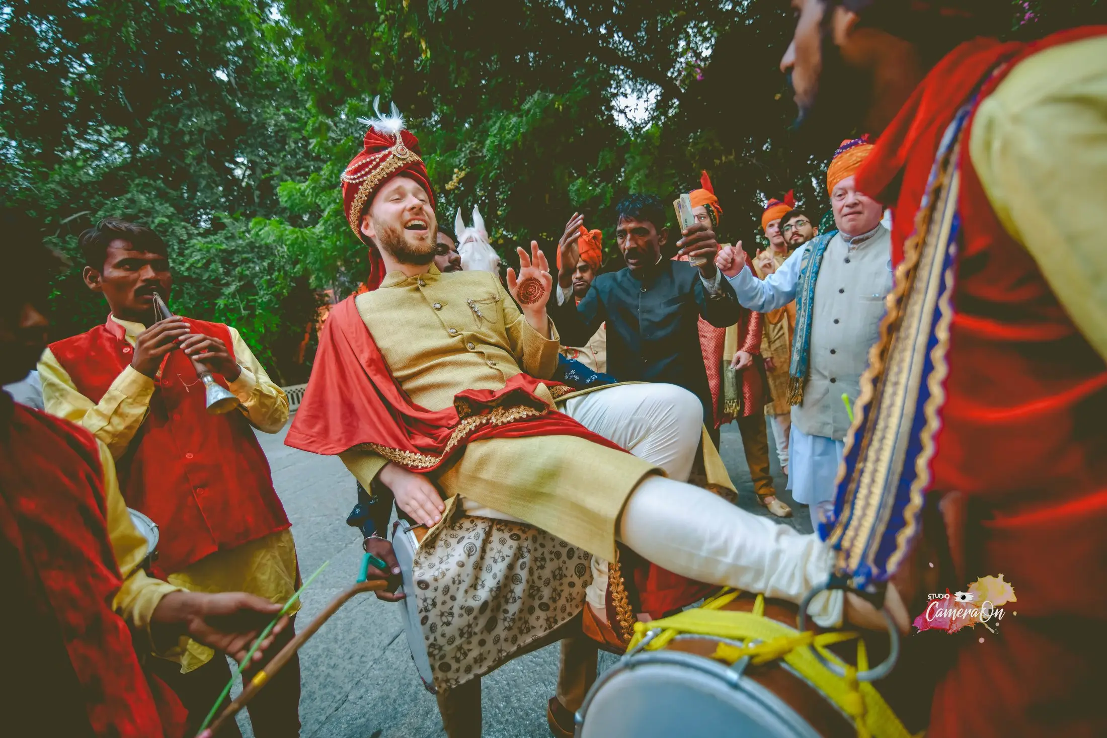 Groom dancing with dhol players during the baraat
